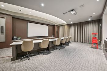 A conference room with a long table and chairs.